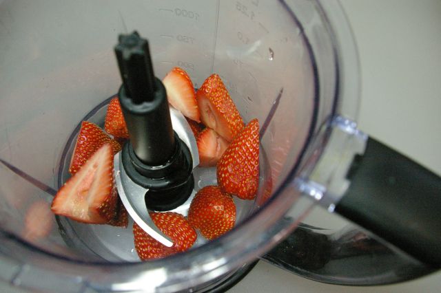 chopping the strawberries for frozen dog treats